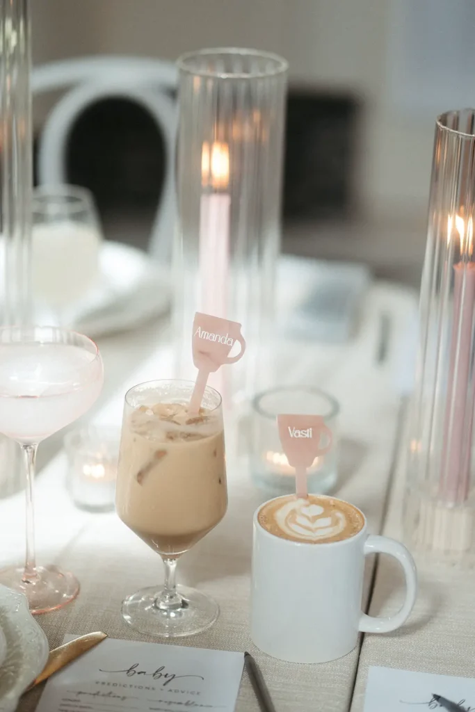 A hot latte in a cup and an iced latte in a glass sitting on an elegantly decorated table