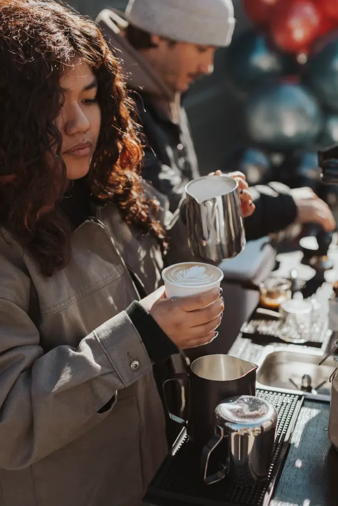 A barista creating latte are