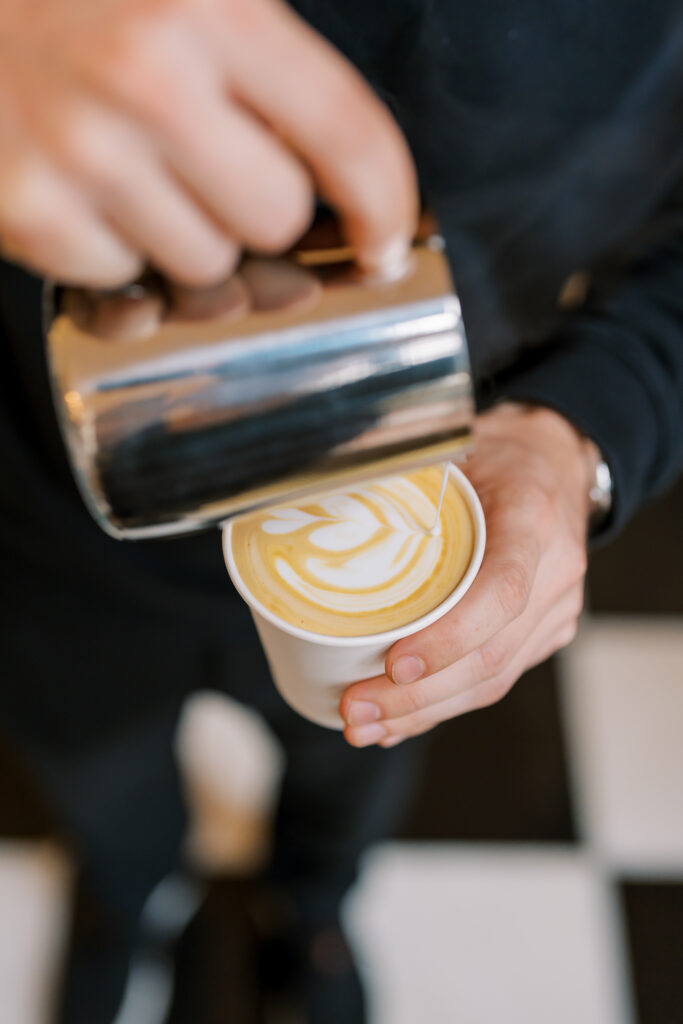 Roaming Spirits Coffee|Mobile Coffee Cart Charlotte professional event barista pouring latte art.