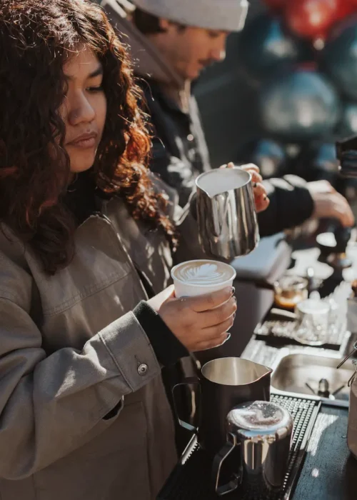 A barista creating latte are